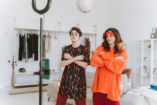 A mother and son record a fun dance video at home using a smartphone and ring light.