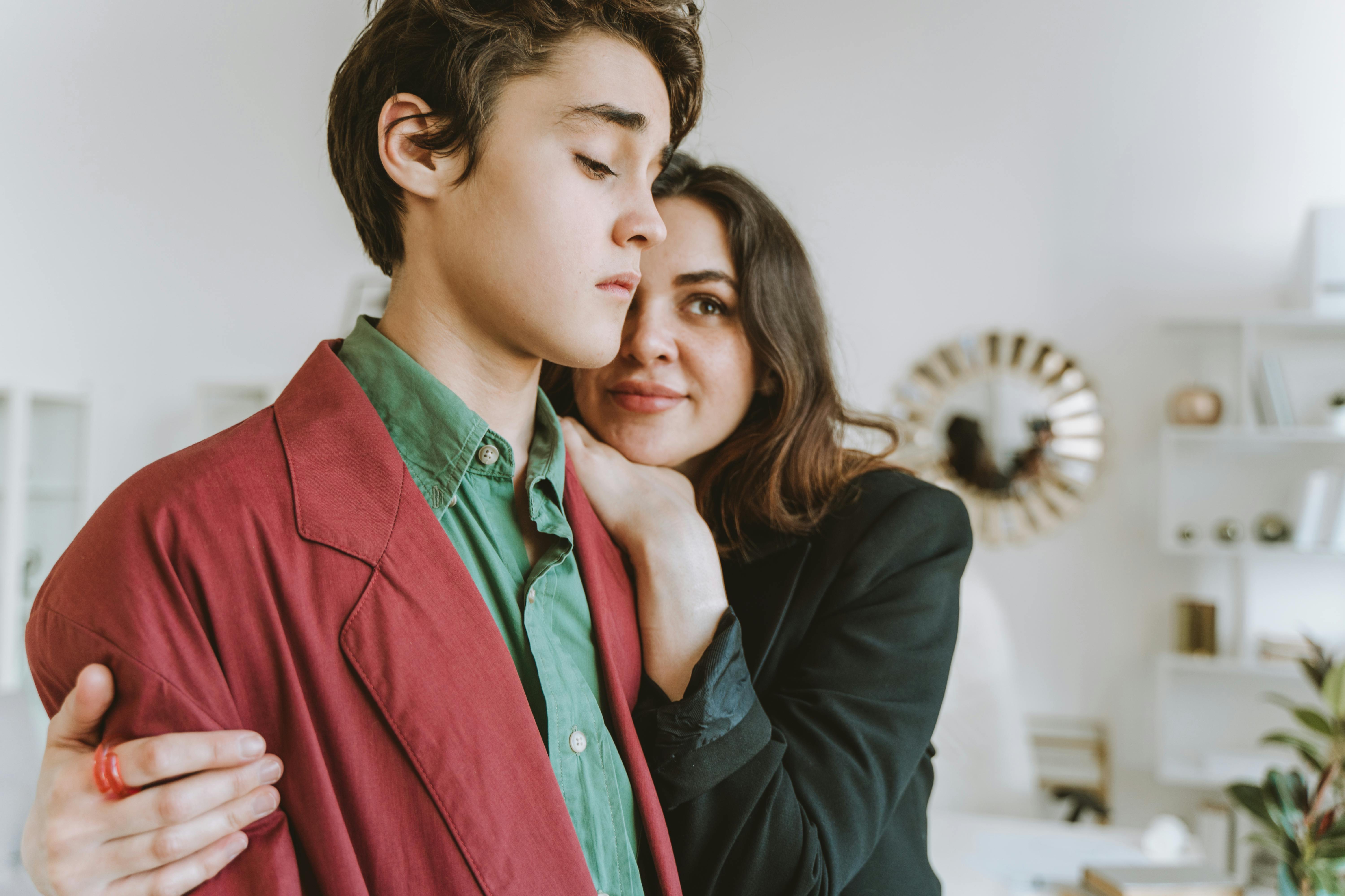 a young man and a woman in formal wear