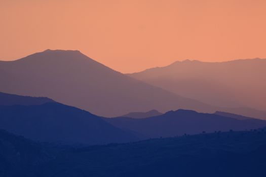 Enchanting sunset view of Giresun's layered mountain ranges with a warm, misty ambiance.