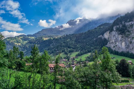 Discover a picturesque alpine village nestled among majestic mountains and lush forests.