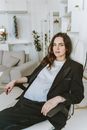 A Woman Sitting on a Swivel Chair