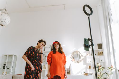 Free A stylish mother and teenage son capture a moment in a chic, well-lit home studio. Stock Photo