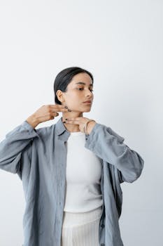 A woman engages in a self-care neck massage routine indoors.