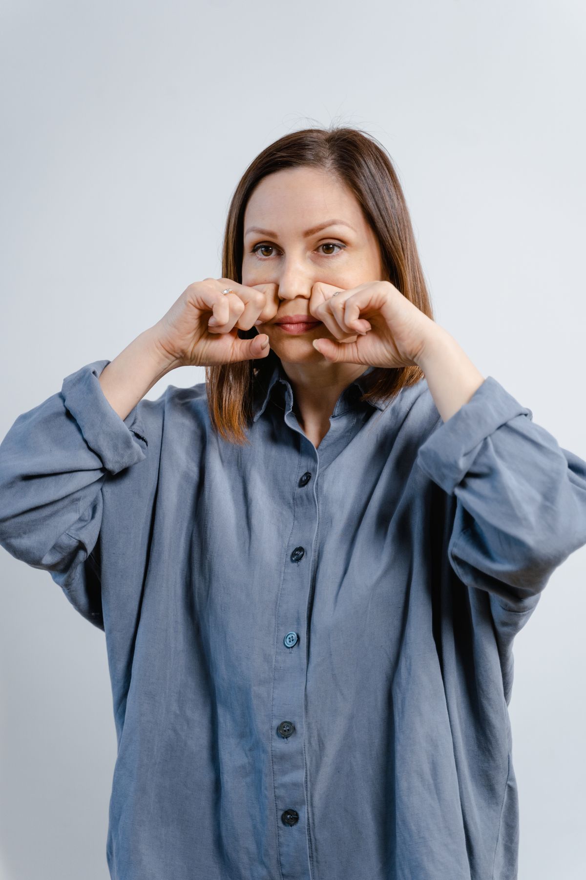Woman performing a facial exercise routine