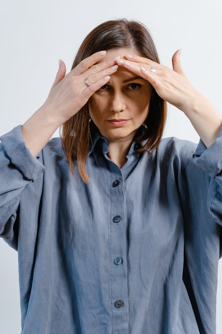 Woman Touching Her Forehead