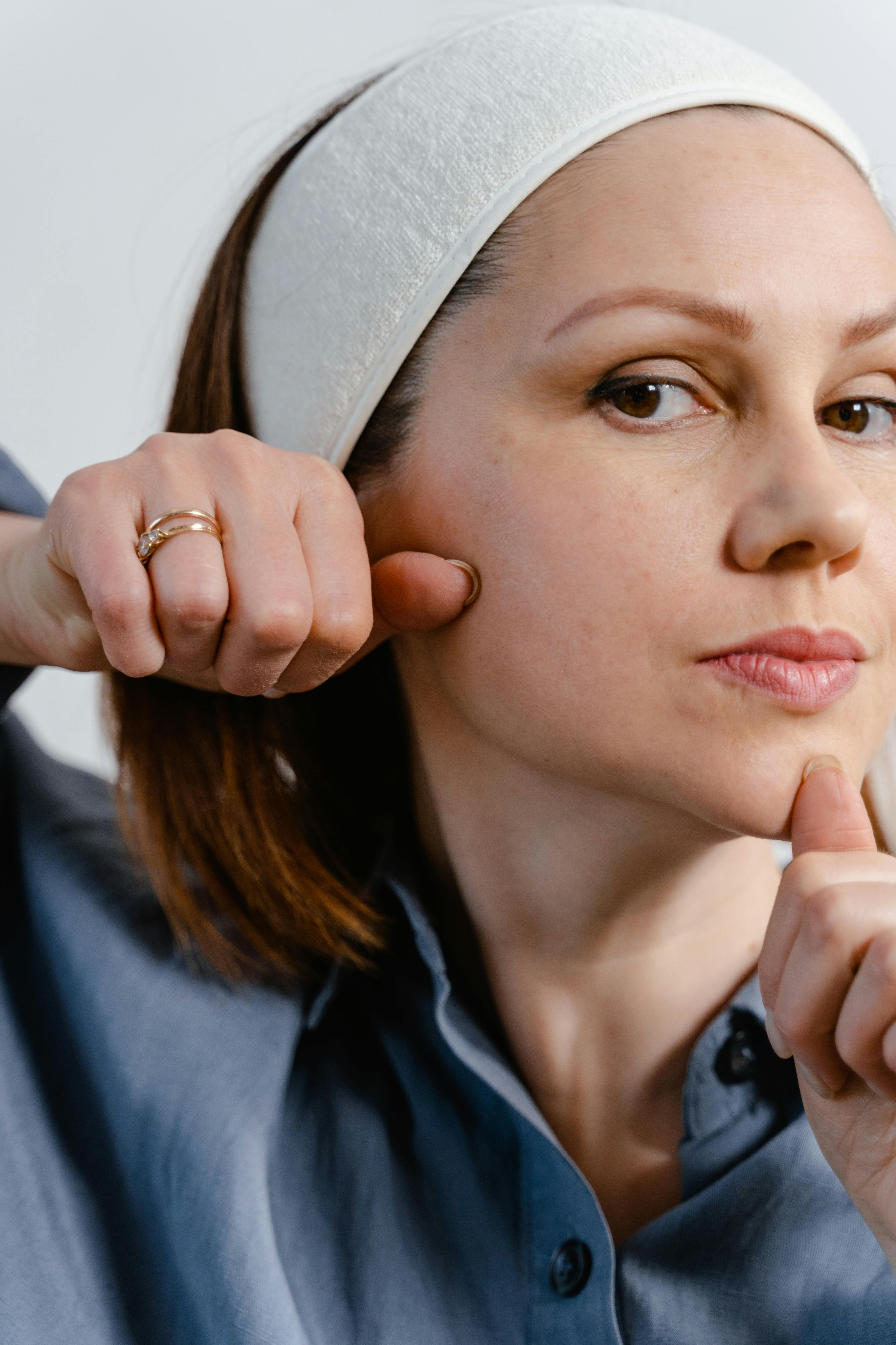 woman doing facial massage on her face