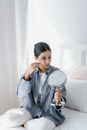 Woman in Blue Dress Shirt Holding Clear Glass Mug
