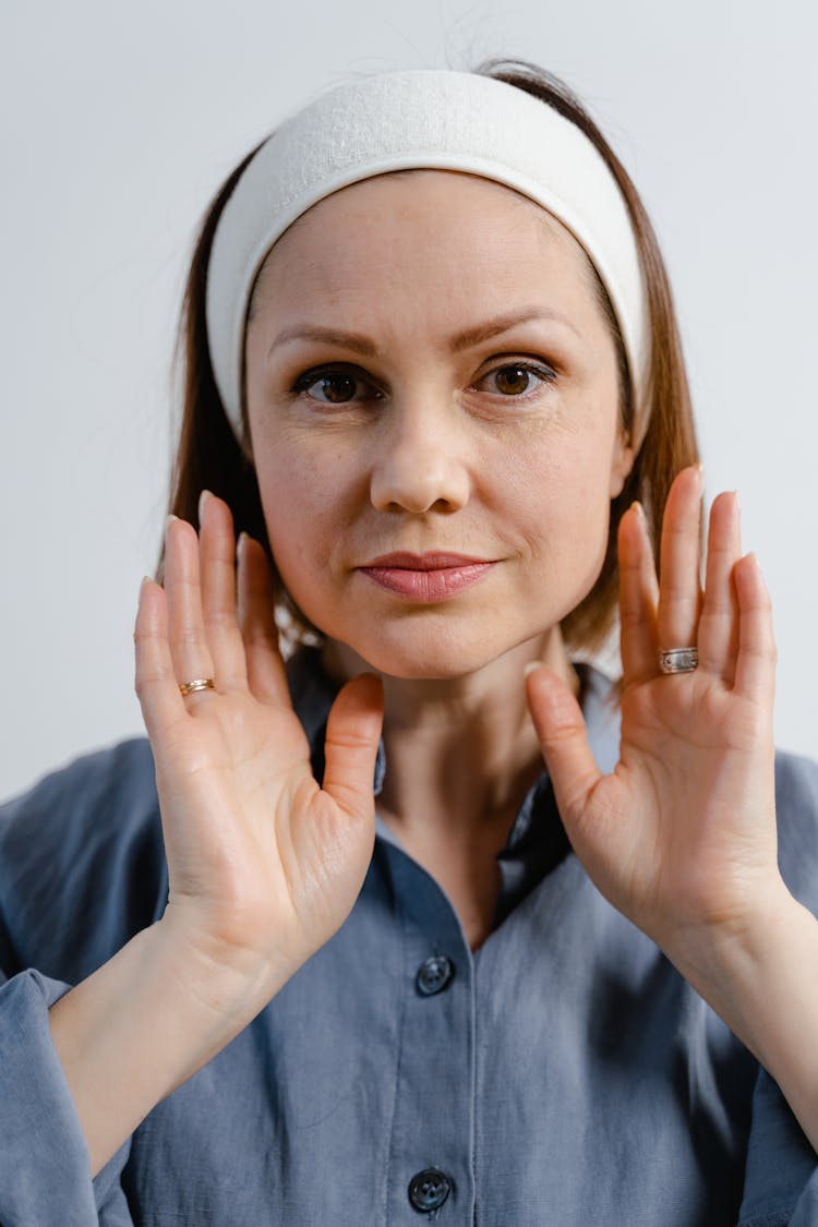 Woman In Blue Button Up Shirt Wearing Facial Headband