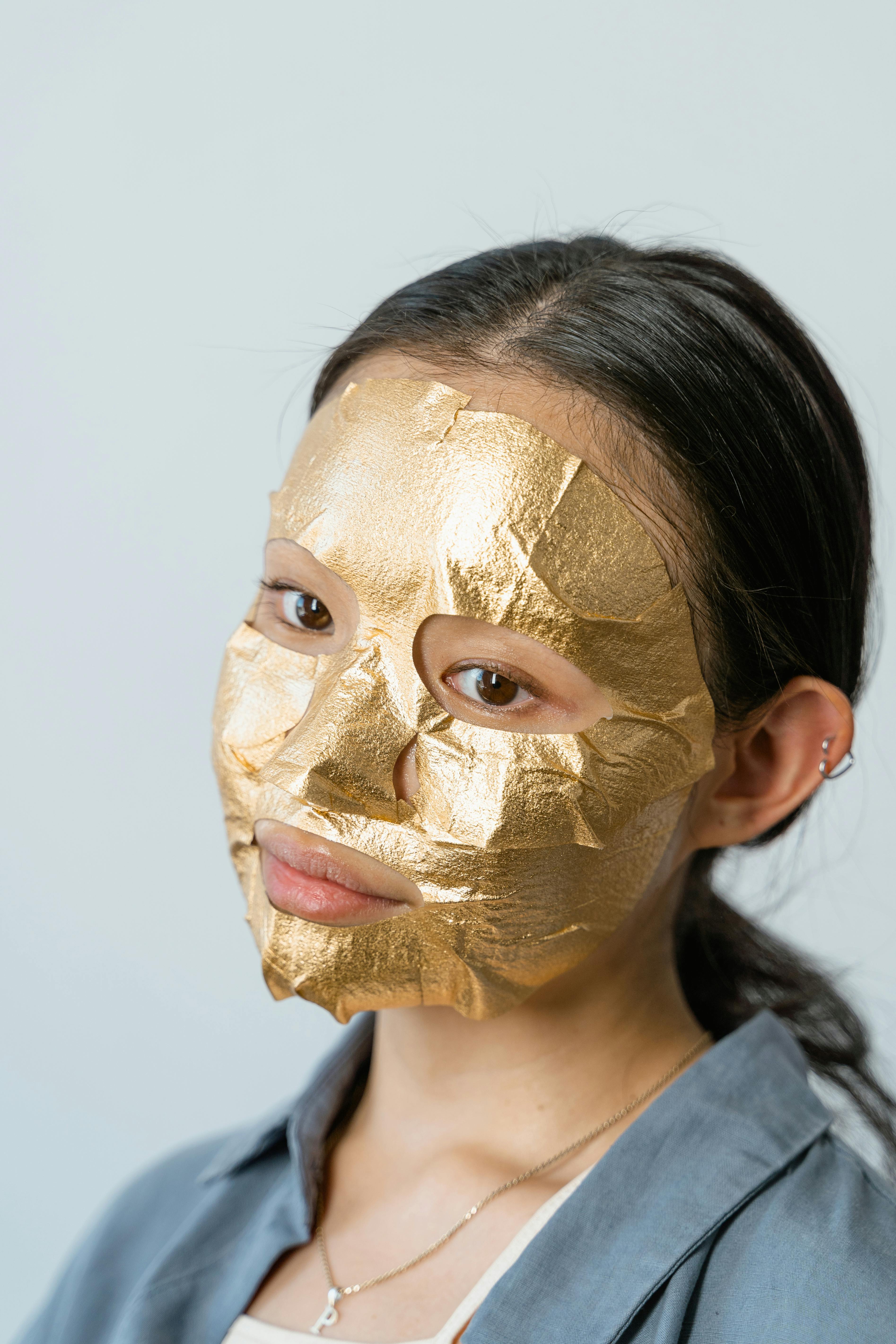 a young woman with a face mask for skin care