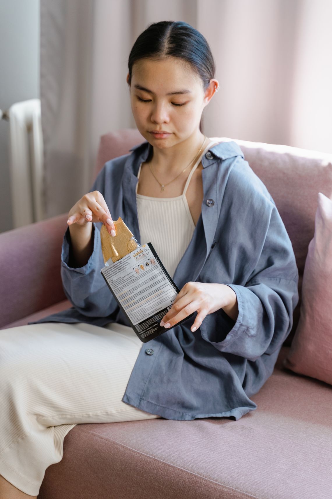 Woman unpacking a skincare product at home