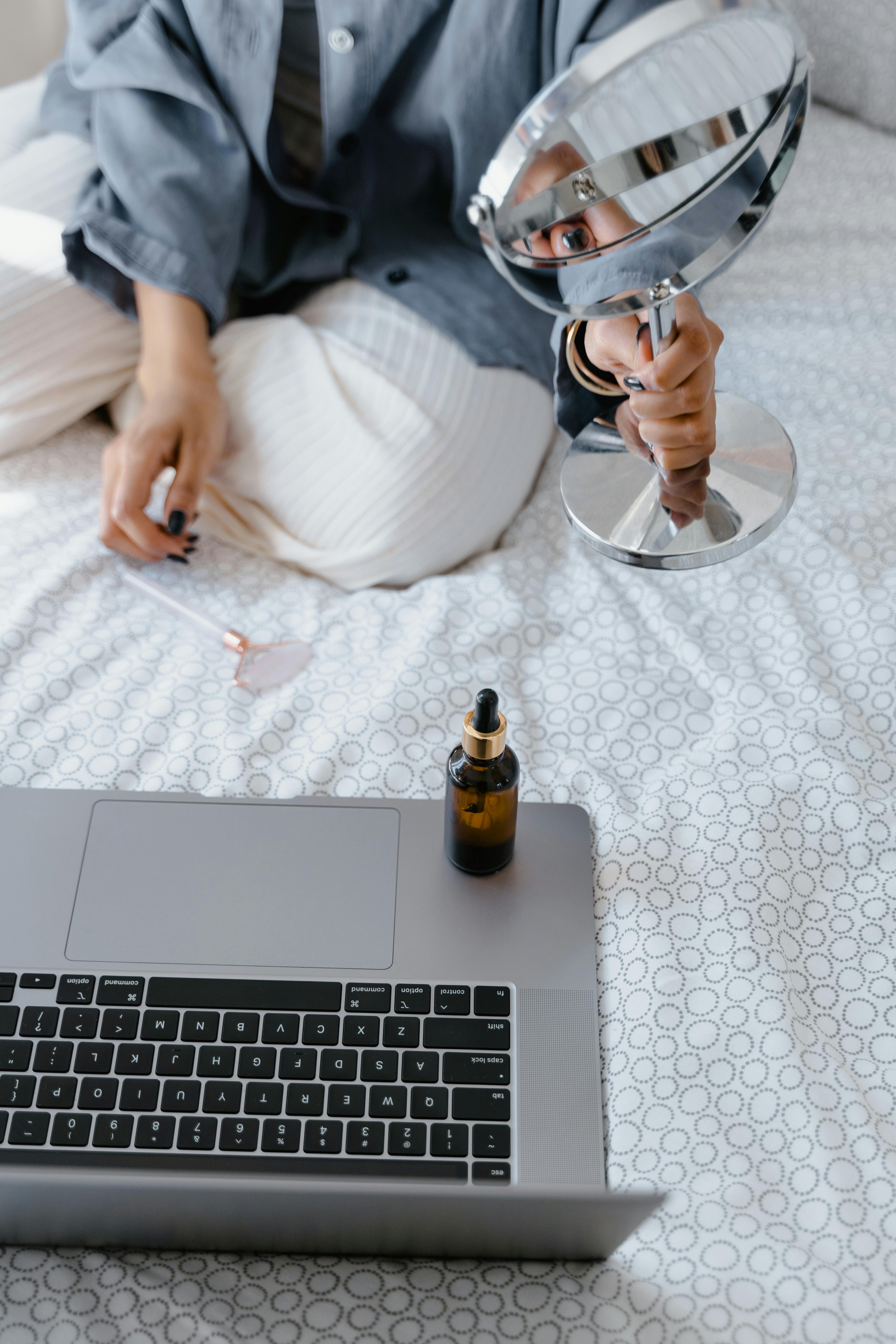 Person Holding Clear Drinking Glass Near Brown Glass Bottle · Free