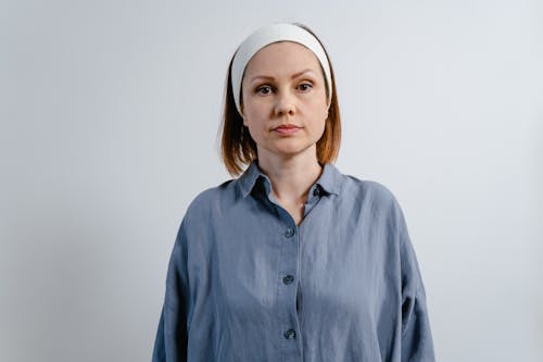 Free A Woman in Gray Long Sleeves Wearing a Headband Stock Photo