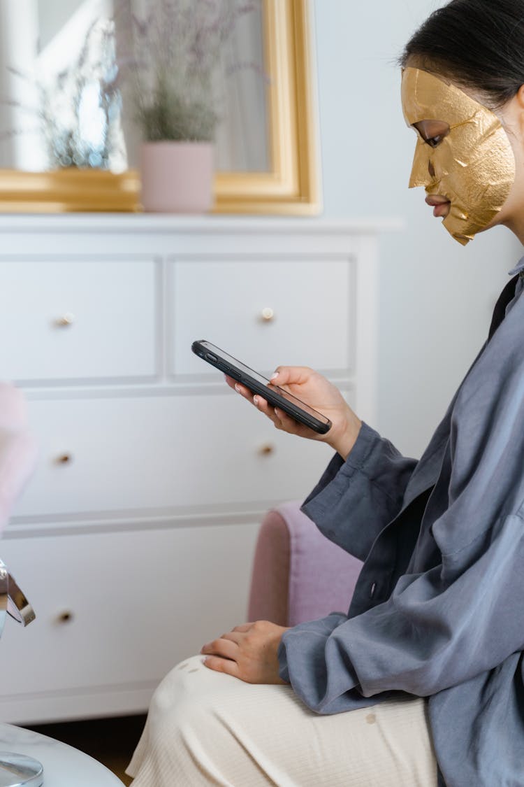 Woman Applied Gold Sheet Face Mask On Her Face 