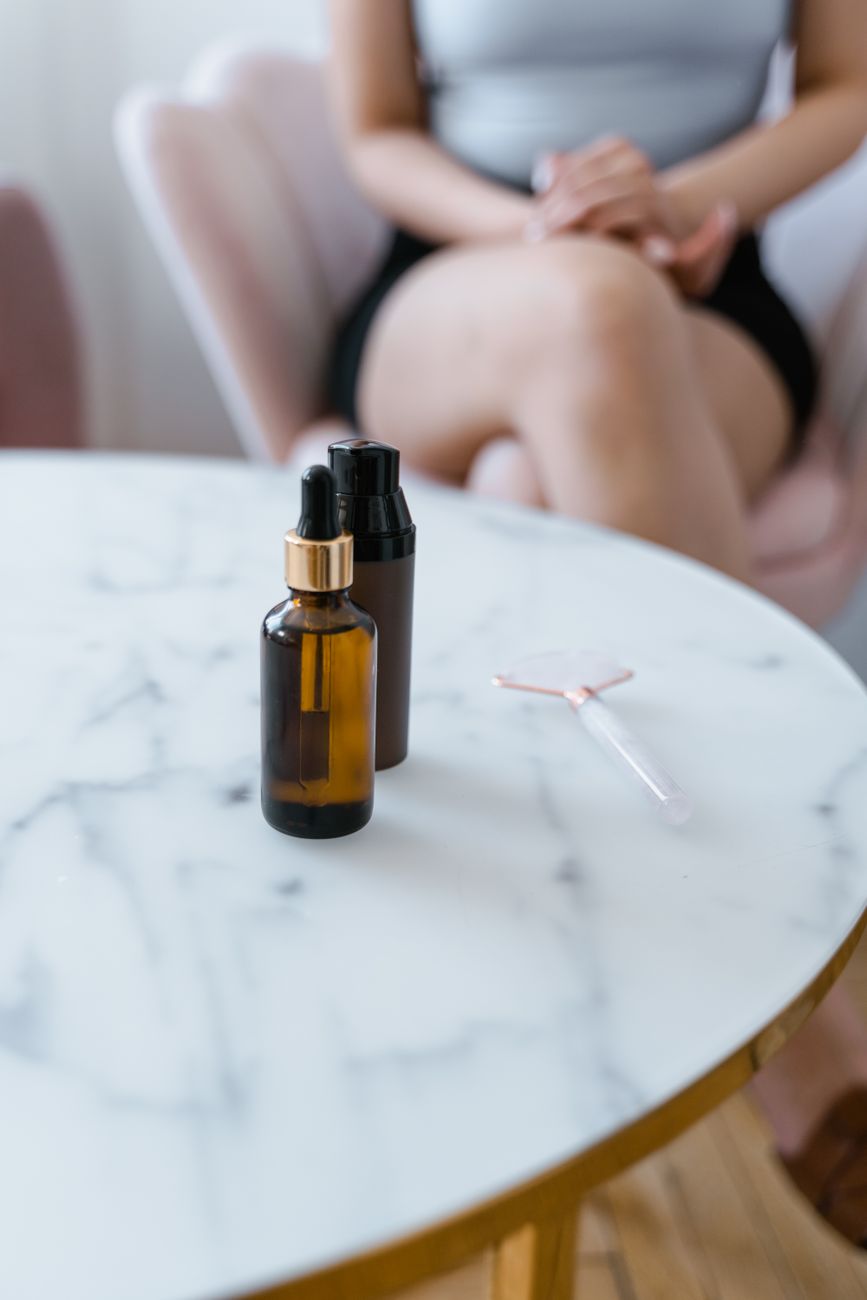 Skincare products and serums on a marble spa table, part of the new beauty-after-injectables economy