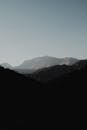 Picturesque scenery of high rocky mountain range under cloudless blue sky in daytime