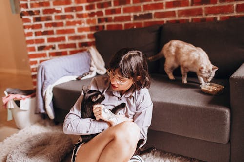 Woman petting her Black Cat 