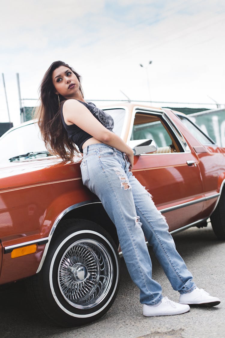 Photo Of Woman Leaning On Parked Car