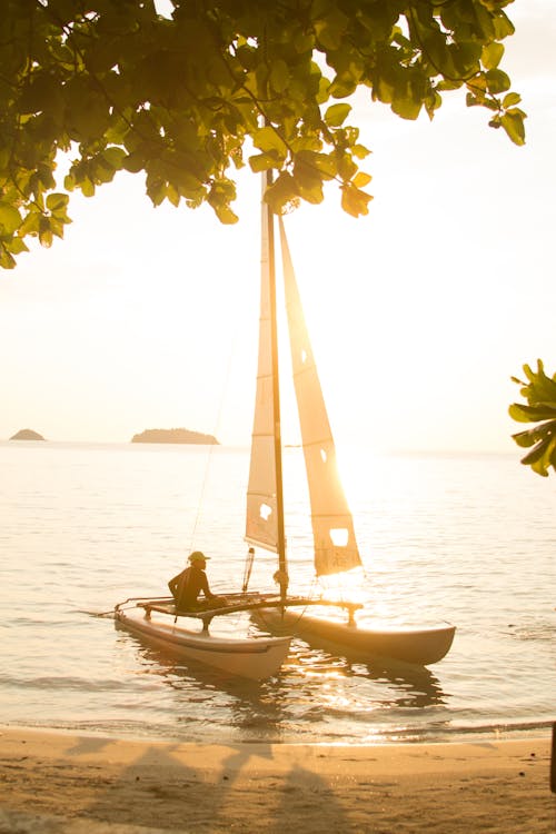 Sailboat on a Beach Shore during Sunset 