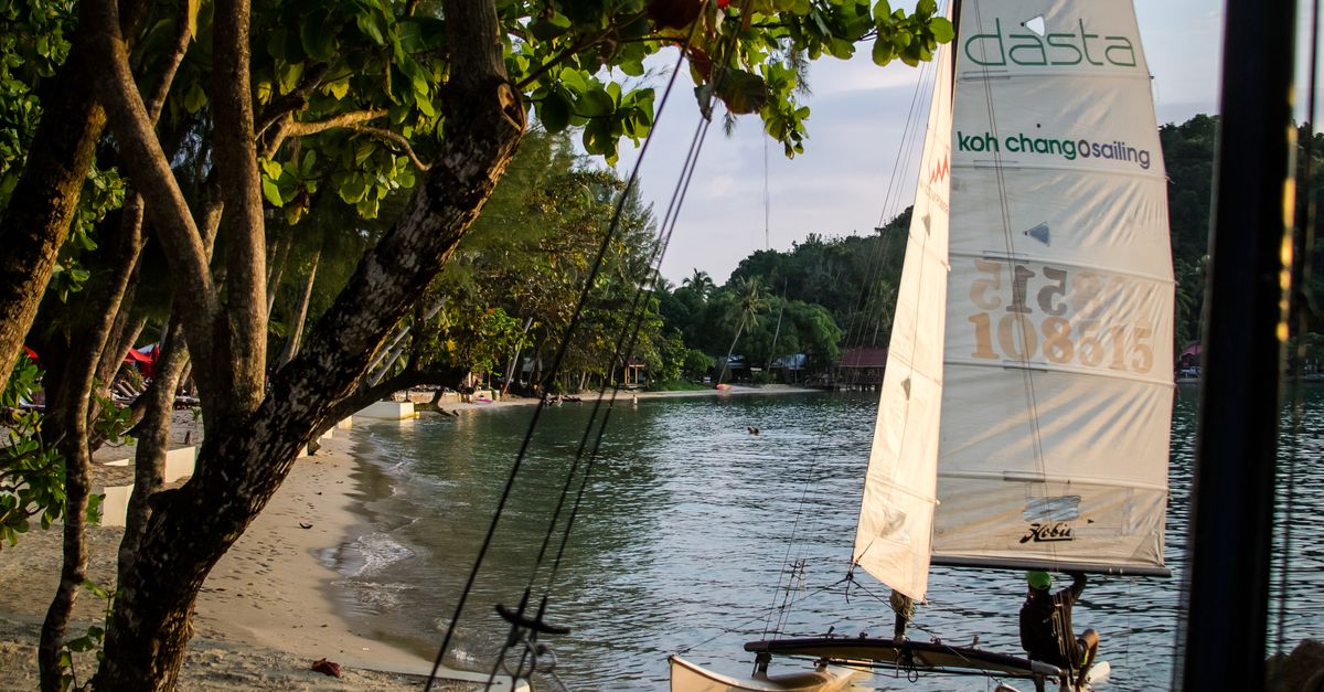Small sailboat on a serene beach at Koh Chang, Thailand, perfect for a tropical getaway.