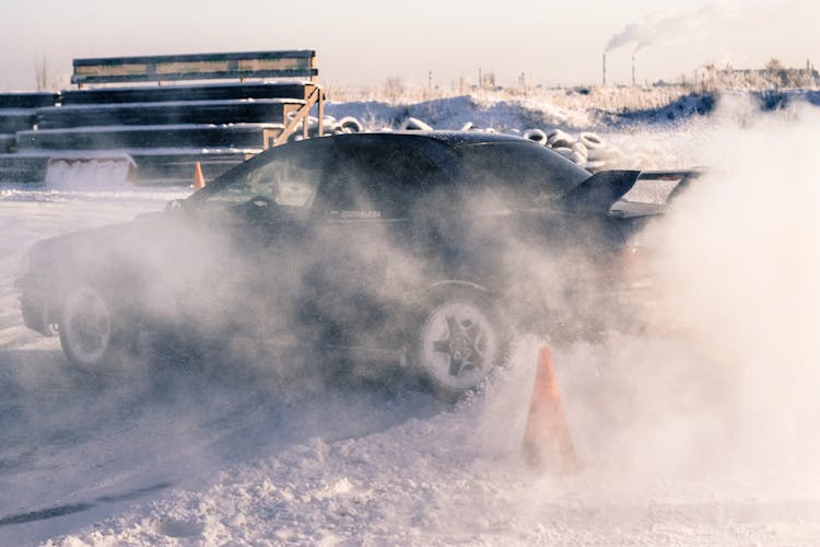 A Black Car Drifting In Snow