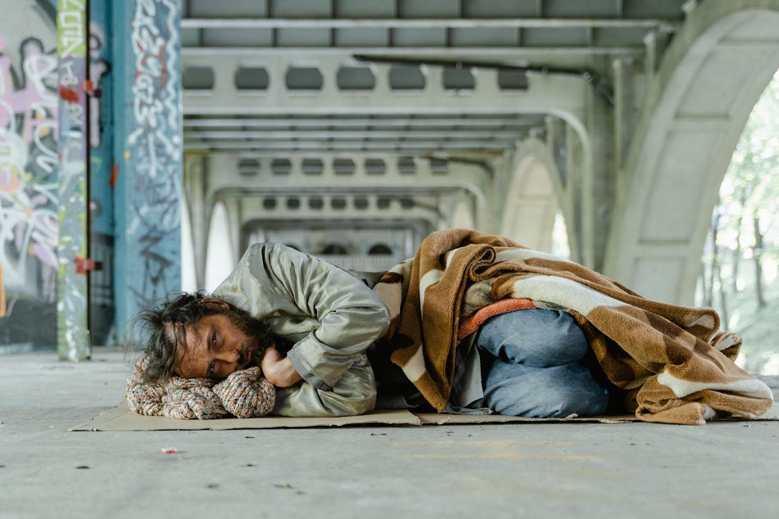 Free Man in Green Jacket Lying on Floor Stock Photo