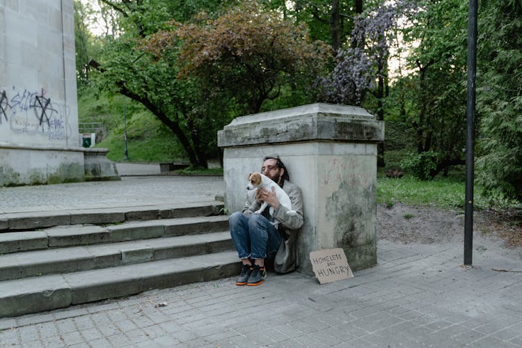 A Homeless Man With A Dog 