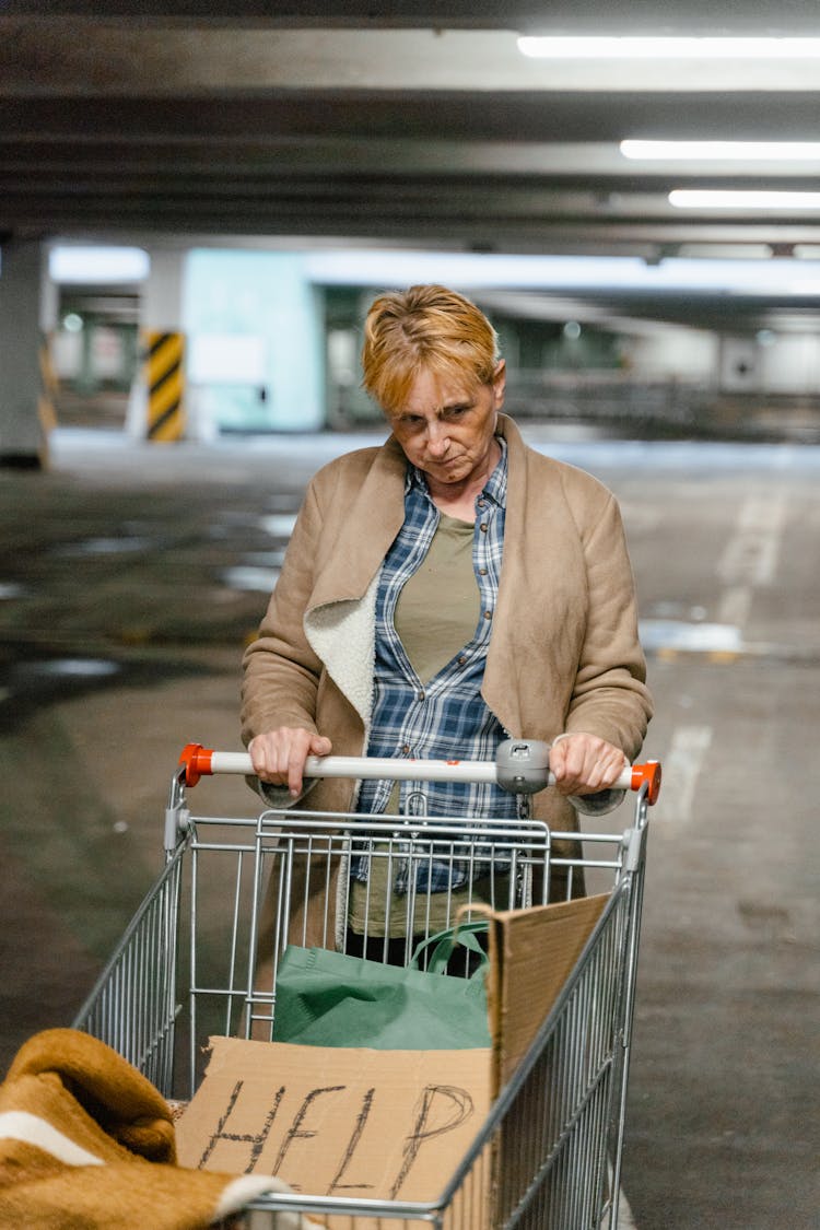 A Homeless Woman At A Parking Lot 