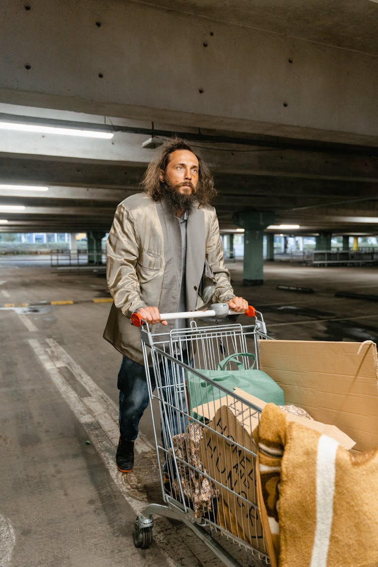 A Homeless Man Pushing Shopping Cart