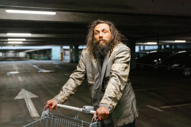 A Homeless Man Pushing Shopping Cart