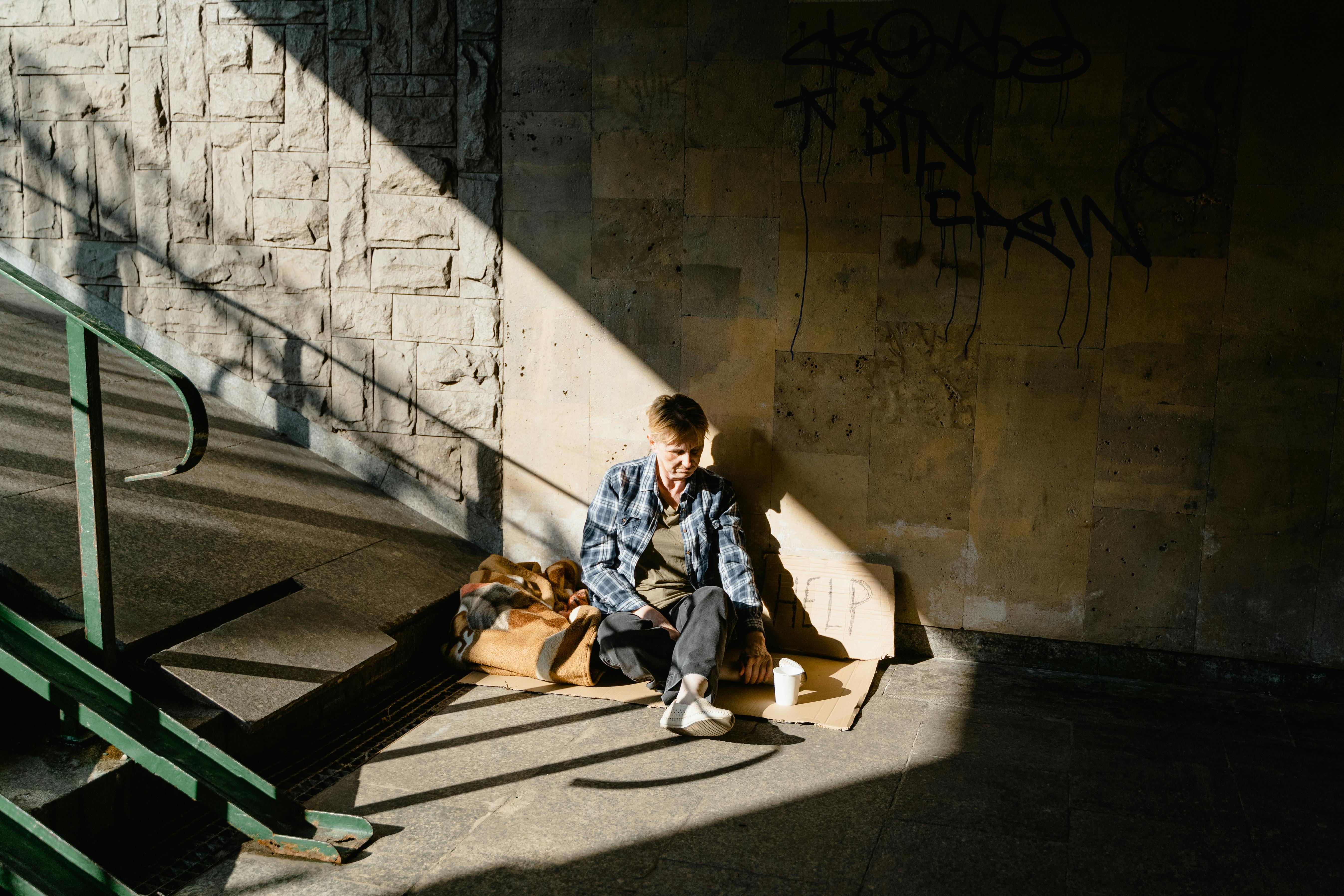 woman in plaid shirt sitting on the ground