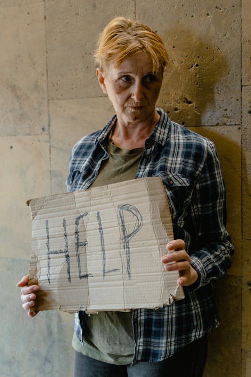 Woman Holding a Help Banner