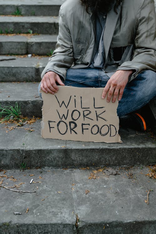 Person Holding a Cardboard Banner