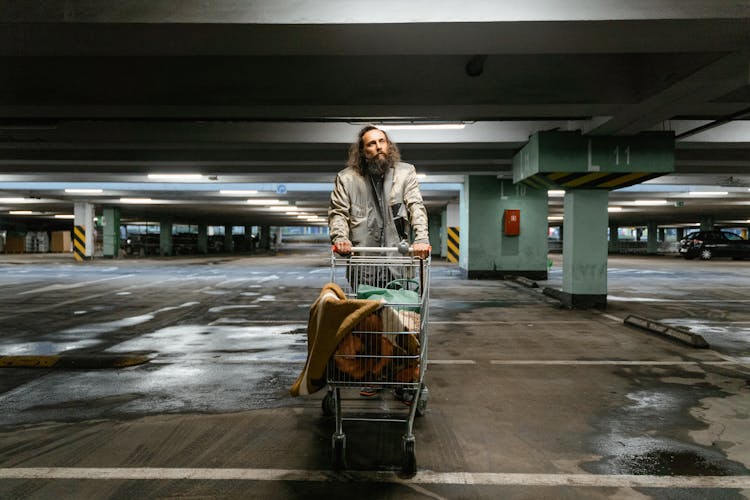 Bearded Man Pushing A Grocery Cart