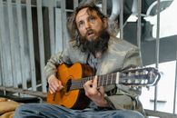 A Homeless Man Playing the Guitar