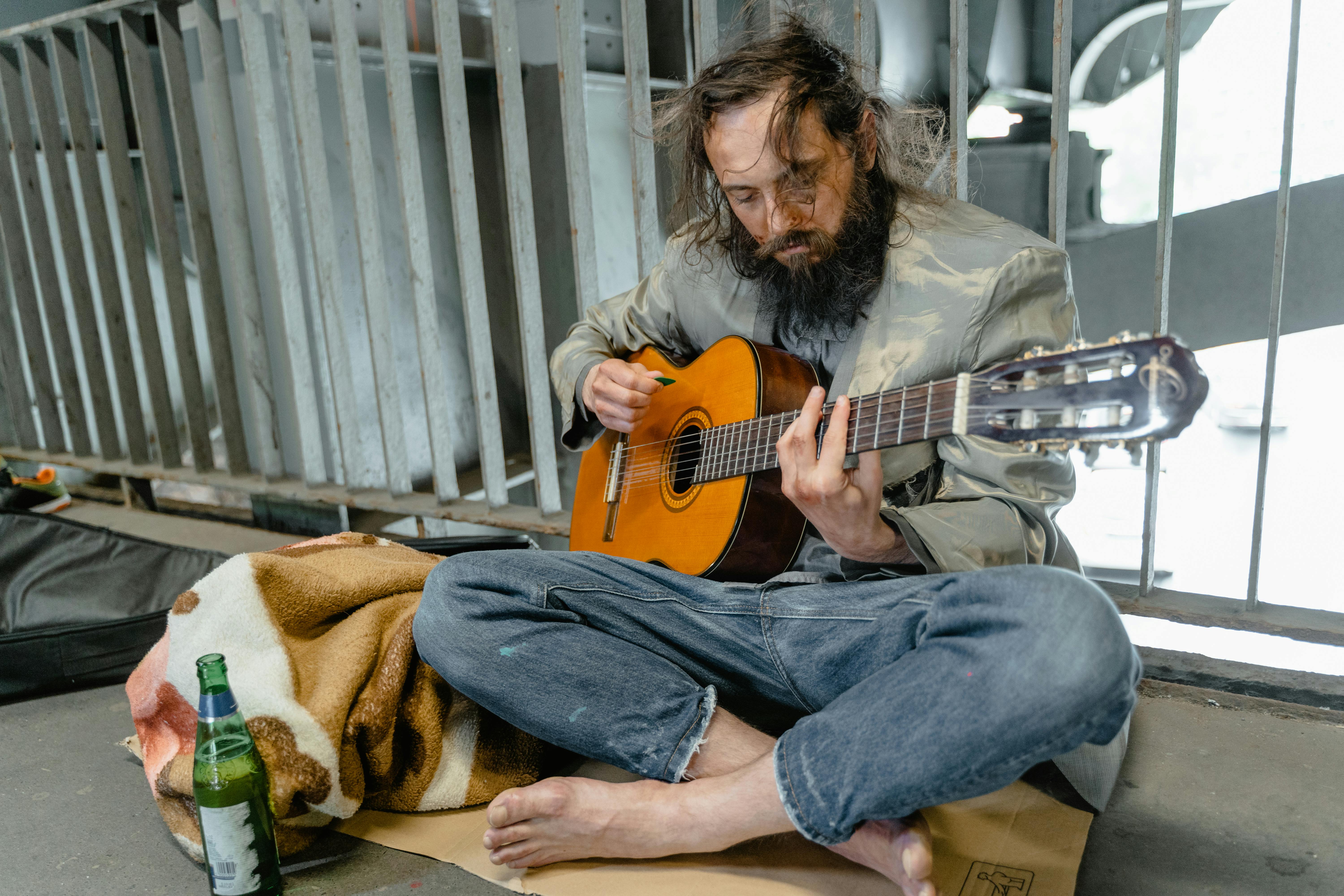 A Homeless Man Playing a Guitar · Free Stock Photo