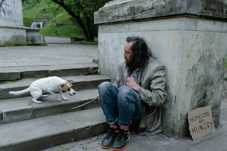 A Homeless Man With A Dog 