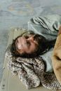 A Male Beggar Sleeping on the Street