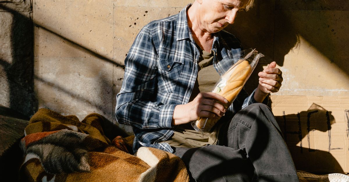 Beggaring A Beggar with a Pack of Bread for Food · Free Stock Photo