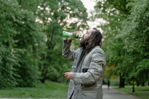 Free Homeless Man drinking on a Glass Bottle  Stock Photo