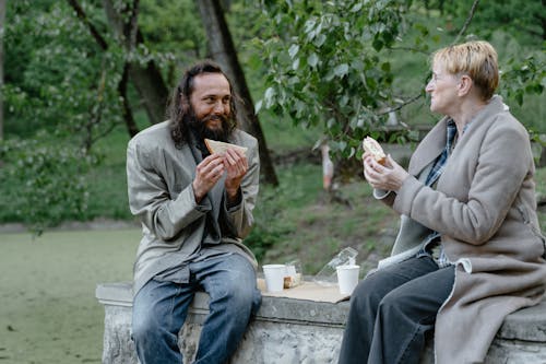 Free Homeless People Eating in the Park Stock Photo