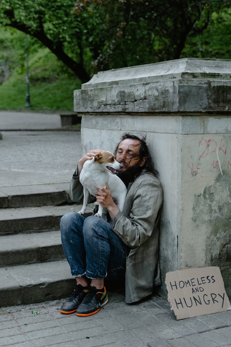 A Homeless Man With A Dog 