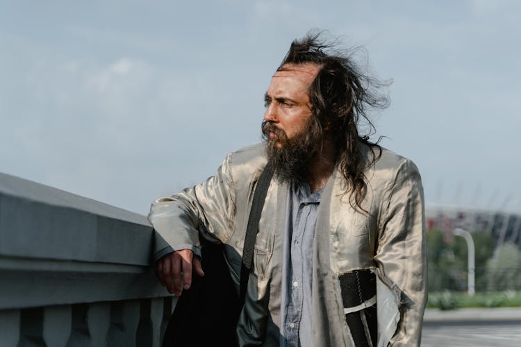 Bearded Man Wearing A Ripped Gray Jacket 