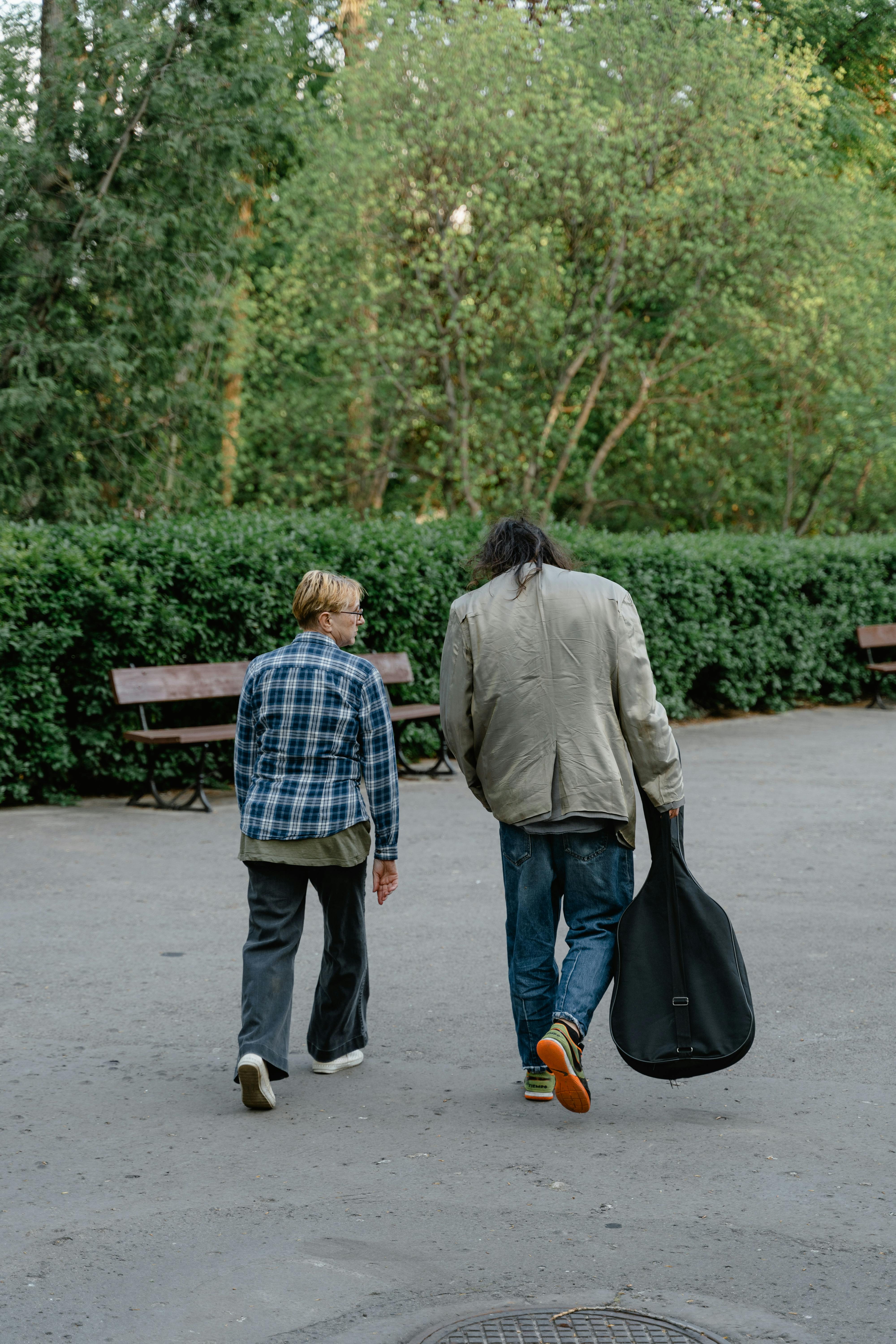 man and woman walking on sidewalk