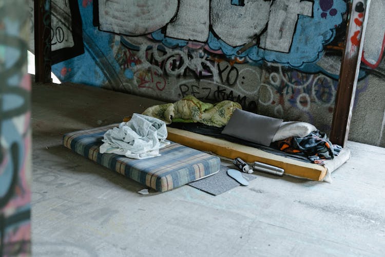 A Mattress Foam Near Vandalized Wall