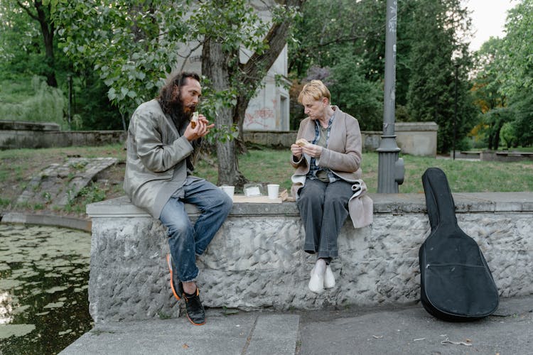 Man And Woman Eating On The Street