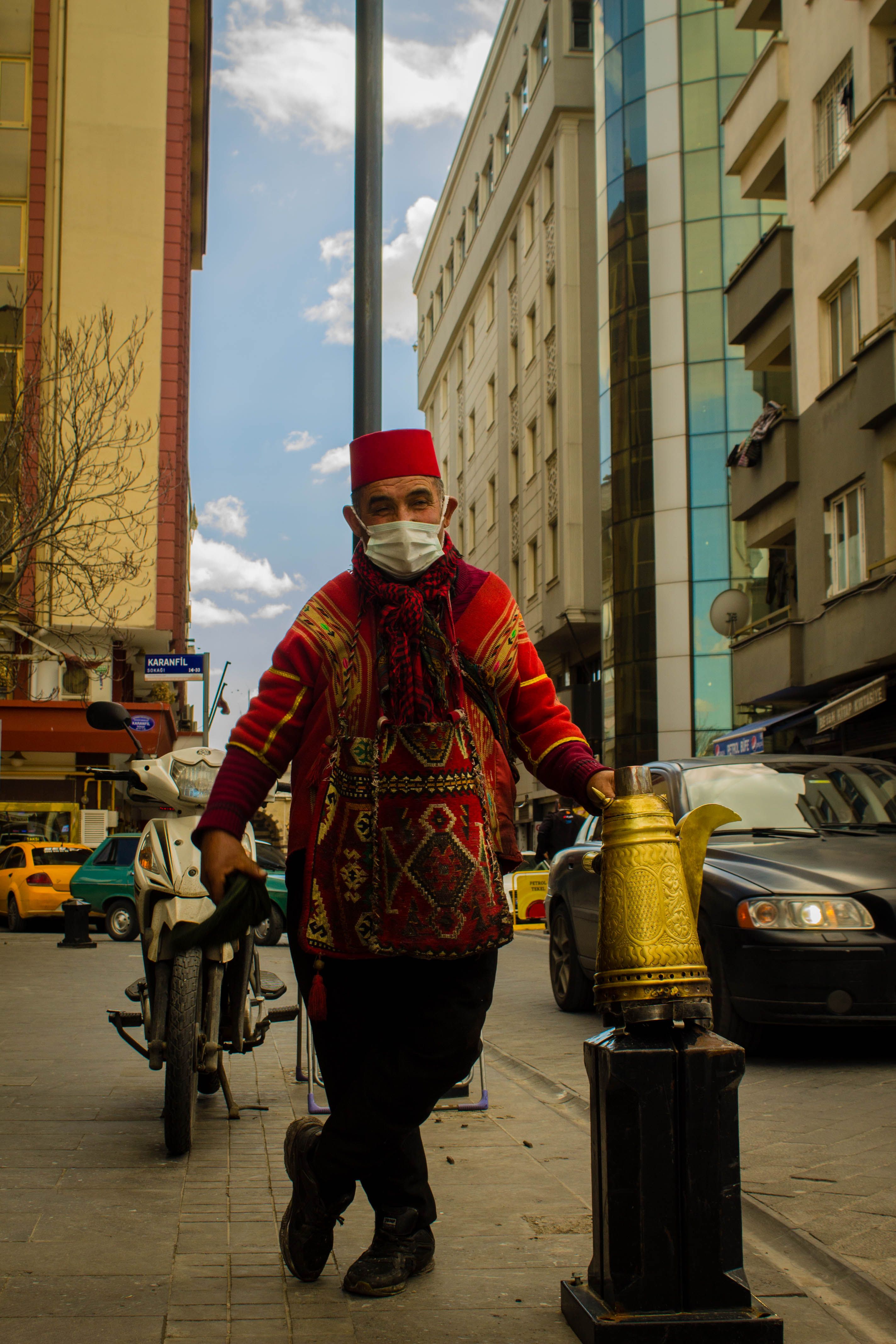 Man in Traditional Clothing and a Face Mask Standing on a City Street ...