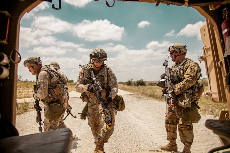 Military Men Holding Guns