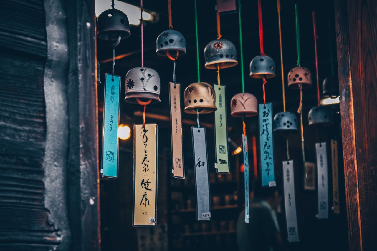 colorful japanese wind chimes hanging in a shop showcasing traditional