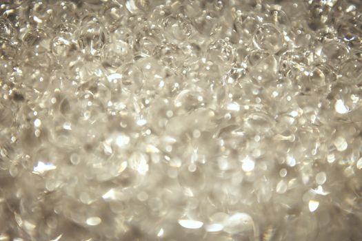 Close-up view of sparkling transparent crystal beads with bokeh effect.