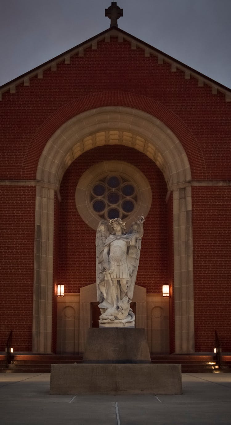 An Angel Statue In Front Of A Church